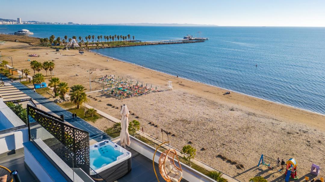 <p>Penthouse for sale in the first line at the beach, near Hotel Adriatik. It is located on the 5th floor with an elevator. Penthouse is organized into two bedrooms, one of which has an en-suite bathroom, the main bathroom, and a large living room together with a kitchen corner that has 3 windows with a direct sea view. Also, on the front side, there is a veranda with an area of 45 m² that offers a 180-degree sea view, and through stairs, a terrace with an area of 60 m² is utilized. The veranda also has a jacuzzi for 5 people. One of the bedrooms also has a balcony with a view of the complex's swimming pool nearby. The apartment is sold fully furnished in detail, ready for living or to be used for daily rental through Booking or Airbnb. Penthouse has an internal area of 82 m², and a total area including verandas of 217 m², it also has a garage on floor -1. The property has proper legal documentation. For a visit to the property, please contact us!</p>