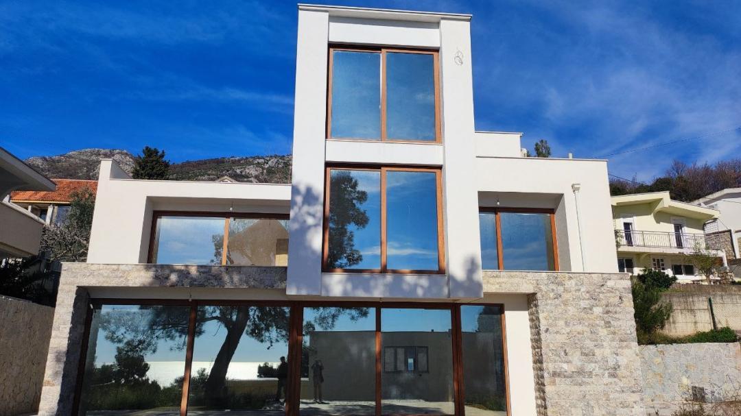 <p>Престижная недвижимость для ценителей уединения, выразительной архитектуры и грамотно спроектированных инженерных решений.</p><p>Вилла расположена в 400 метрах от моря, на тихой улице, окружённой соснами. Дом построен в соответствии с утверждённым архитектурным проектом и имеет действующее разрешение на строительство.</p><h3>Архитектурные параметры</h3><ul><li>Общая площадь дома: 292 м² + просторная терраса первого уровня</li><li>Площадь участка: 400 м²</li><li>Дополнительно: 100 м² общей зоны (гостевая парковка)</li><li>Отдельный гараж: 40 м² (с разрешением на строительство)</li><li>Частная парковка перед домом</li></ul><p>Недвижимость формирует характерный трёхуровневый архитектурный объём с продуманным разделением приватных и общих зон.</p><h3>Планировка</h3><p><strong>1-й этаж:</strong><br>Гостиная с выходом к бассейну, столовая, кухня, ванная комната, лестница, большая терраса.</p><p><strong>2-й этаж:</strong><br>3 спальни, ванная комната, 2 просторных балкона.</p><p><strong>3-й этаж:</strong><br>1 главная спальня, ванная комната, 2 больших балкона.</p><p>Планировка разработана с целью максимизации панорамных видов и естественного солнечного освещения.</p><h3>Инженерные решения</h3><p>Недвижимость подготовлена для эксплуатации на высоком уровне и комфортного проживания:</p><ul><li>Центральное отопление (тёплый пол)</li><li>Возможность установки отопительного котла или солнечных панелей</li><li>Подготовка подключений для теплового насоса</li><li>Подводка радиаторов в спальнях</li><li>Подготовка к центральной системе кондиционирования</li><li>Подключение к городскому водопроводу и канализации</li><li>Дополнительный водоём объёмом более 18 м³</li></ul><h3>Бассейн</h3><p>Перед домом расположен переливной бассейн размером 7 × 3,5 м.</p><p>Строительные работы завершены; установка системы циркуляции, фильтрации и освещения предусмотрена.</p><h3>Текущий этап готовности</h3><p>Планируются следующие работы:</p><ul><li>Установка сантехнического оборудования</li><li>Установка перил и ограждений</li><li>Установка климатического и отопительного оборудования</li><li>Установка котлов</li><li>Благоустройство территории, ограждения и наружное освещение</li><li>Финальная отделка бассейна</li></ul><p>Недвижимость предлагается на высоком этапе строительной готовности, что позволяет будущему владельцу реализовать индивидуальную концепцию интерьера.</p><p>Эта вилла представляет собой рациональный выбор для клиента, который ценит юридическую прозрачность, надёжную инженерную подготовку и стратегически привлекательное расположение в зелёной прибрежной зоне <strong>Бар</strong>.</p>